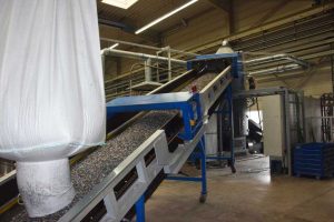plastic recycling plant Erema with regrind plastic on conveyor